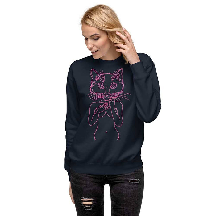 Woman wearing a navy sweatshirt with a pink cat design on a white background