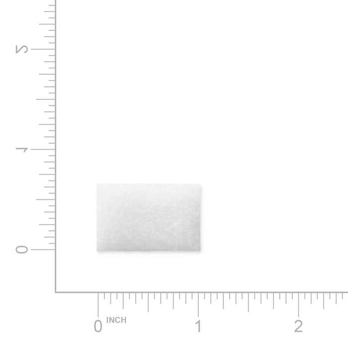 White square filter with textured surface on a white background with measurement scale